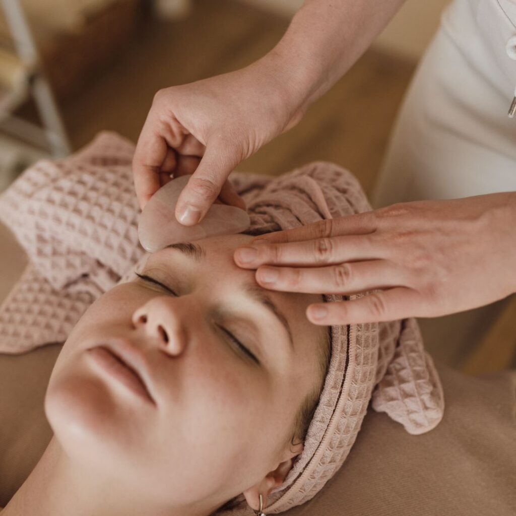 woman massaging a clients face