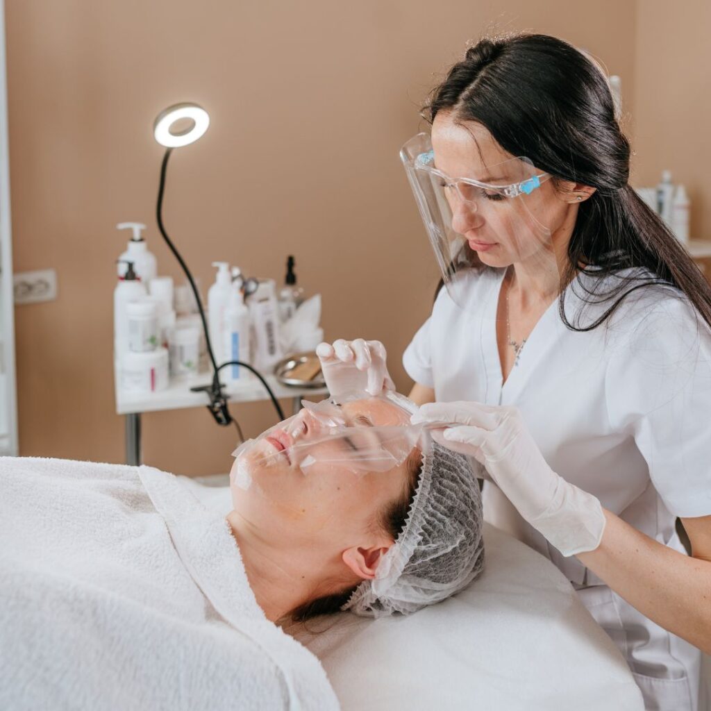woman wearing a face mask while attending to a client