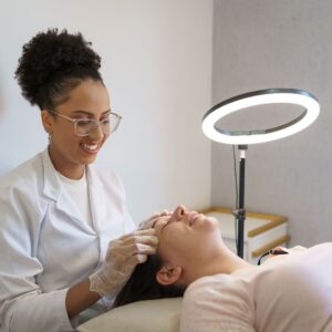 medical esthetician giving facial treatment