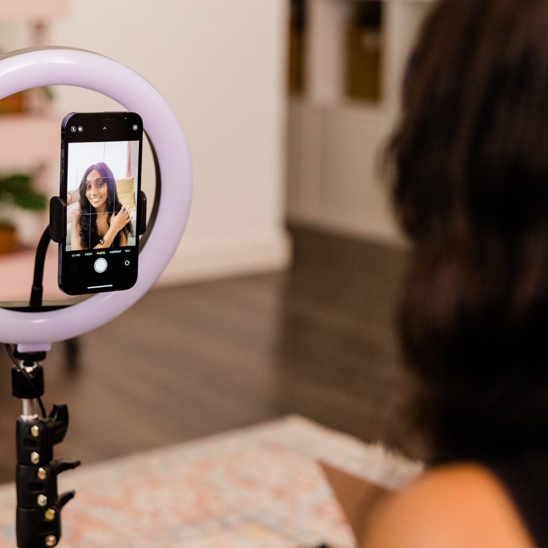 Woman filming herself on a phone