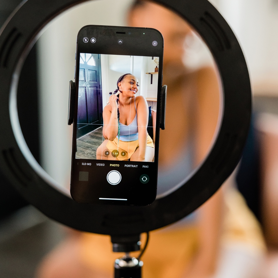 Woman posing for a photo on her phone