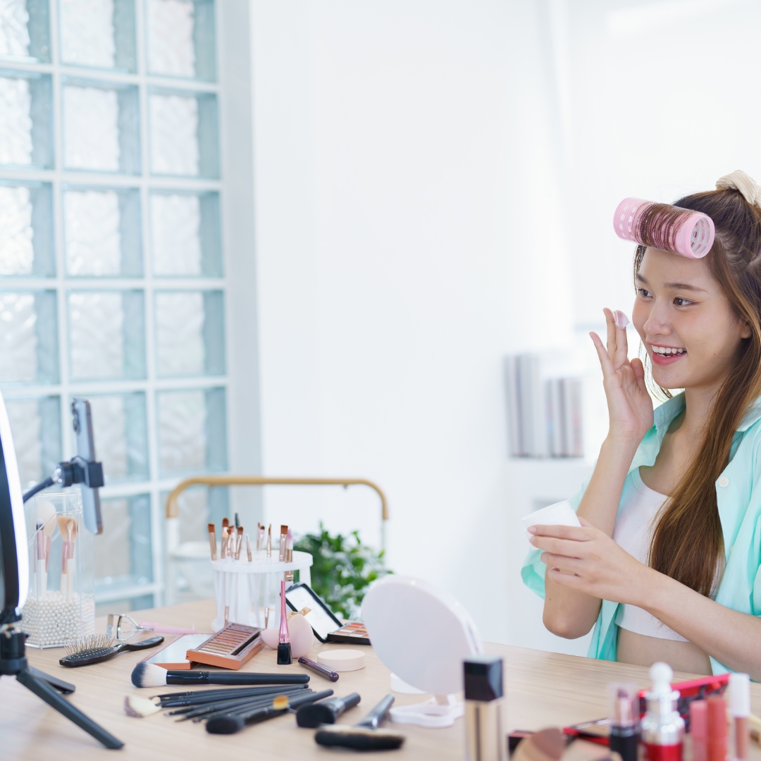 Woman trying on skincare products of a video