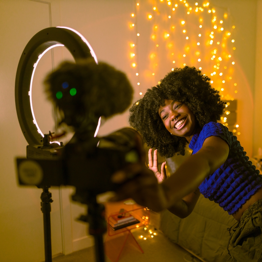 Smiling woman taking a video of herself