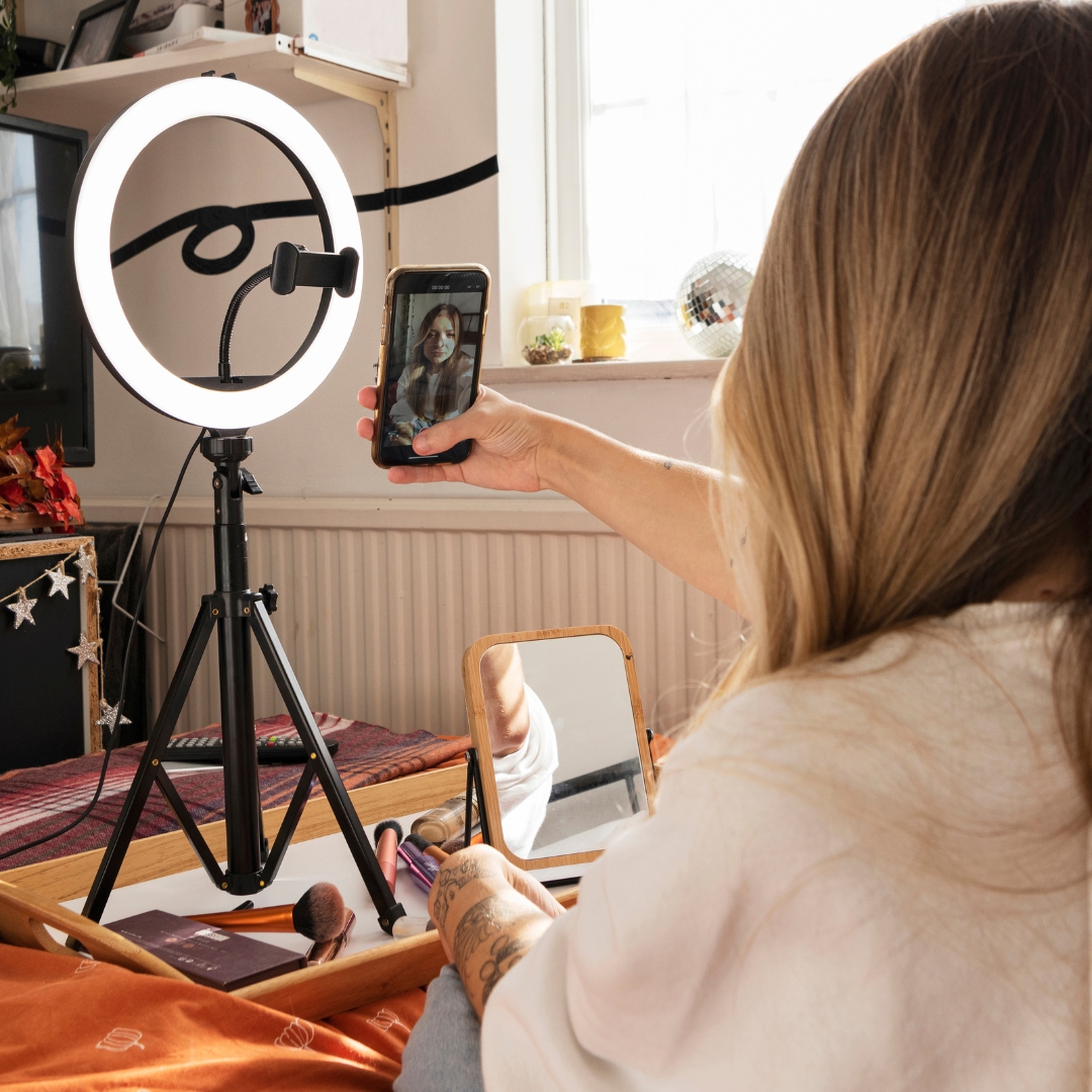 Woman filming a skincare video of herself